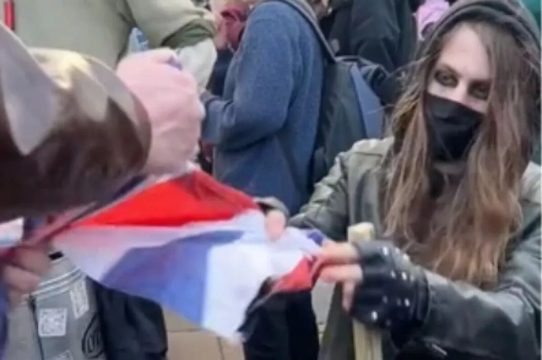 Fury as protesters destroy Union Jack flag in front of police