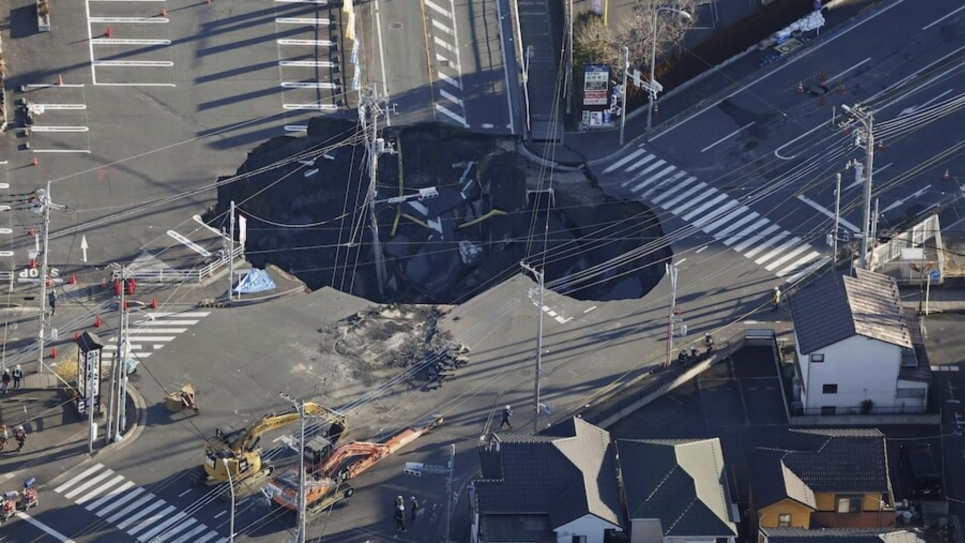 Rescuers in Japan struggle to save truck driver trapped in sinkhole