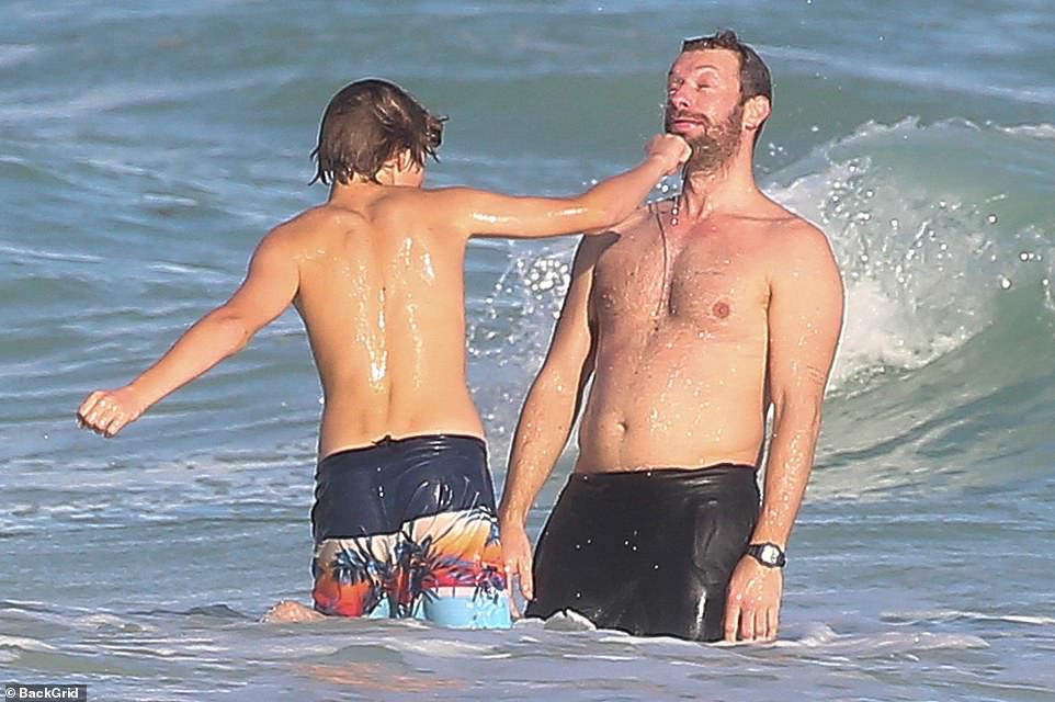 Chris Martin gets a pretend 'punch' to his face by son Moses,15